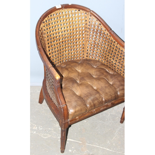 84 - In the manner of John Widdicomb, a pair of bergere and button seated tub chairs with faux bamboo eff... 