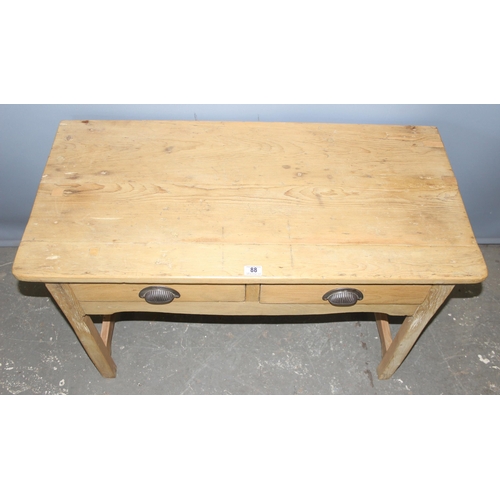 88 - A vintage pine 2 drawer desk with metal cup handles, approx 105cm wide x 52cm deep x 65cm tall