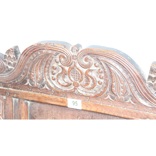 95 - An antique oak Wainscot Elbow Chair with carved and panelled back on turned supports and squared str... 