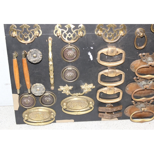 1744 - Display of antique and later handles mounted on painted black board