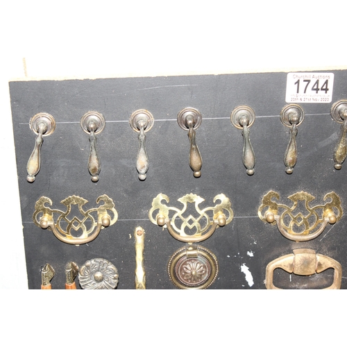 1744 - Display of antique and later handles mounted on painted black board