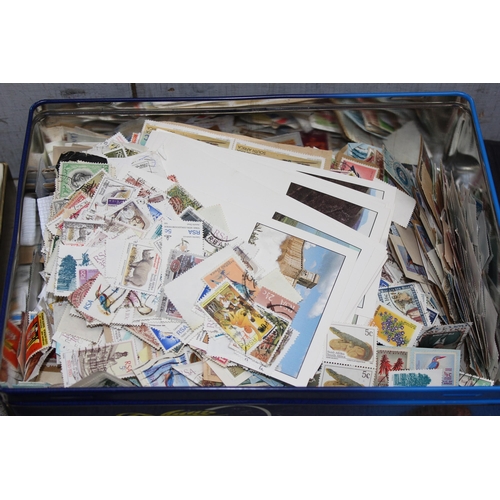 515 - 5 tins of loose mixed world stamps and 2 empty but good quality stamp albums