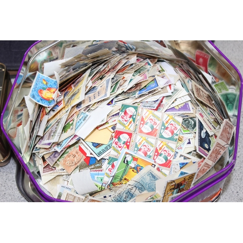 515 - 5 tins of loose mixed world stamps and 2 empty but good quality stamp albums