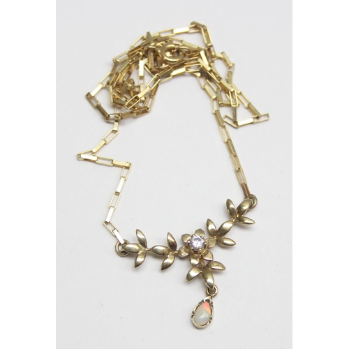 2415 - A 9ct gold necklace set with a small white stone and a small opal drop within and Art Nouveau style ... 