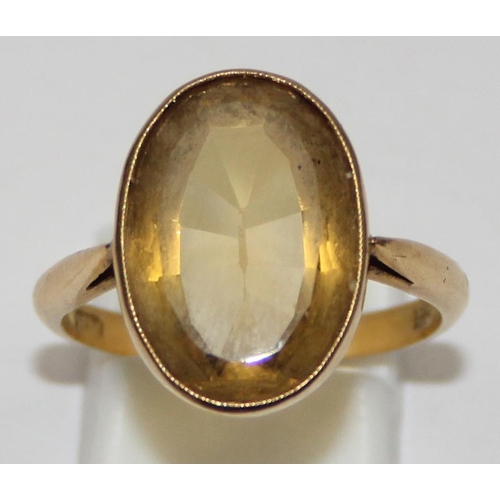 2003 - An antique 18ct gold mounted ring set with a large facet cut yellow stone, possibly a Citrine, marke... 