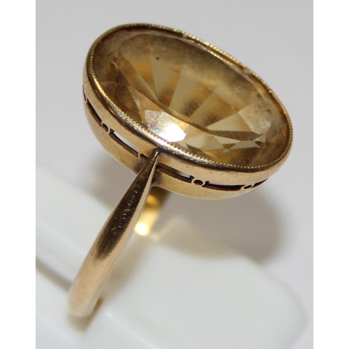 2003 - An antique 18ct gold mounted ring set with a large facet cut yellow stone, possibly a Citrine, marke... 