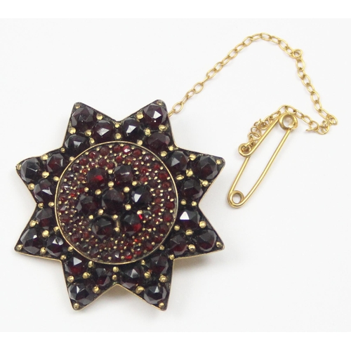 2036 - A 19th century garnet mounted star brooch, mounted in gold plated metal, approx 35mm wide