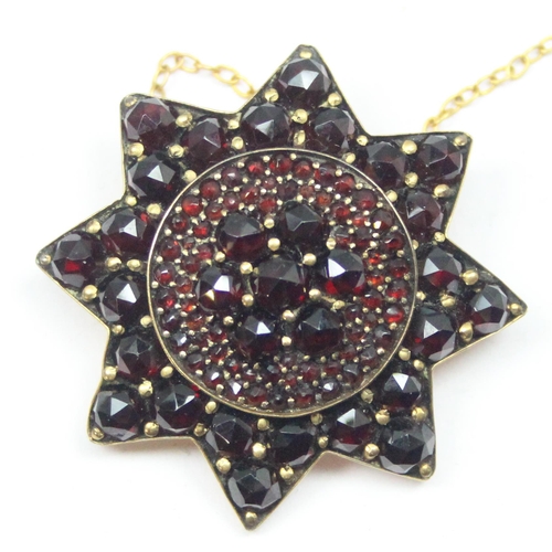 2036 - A 19th century garnet mounted star brooch, mounted in gold plated metal, approx 35mm wide