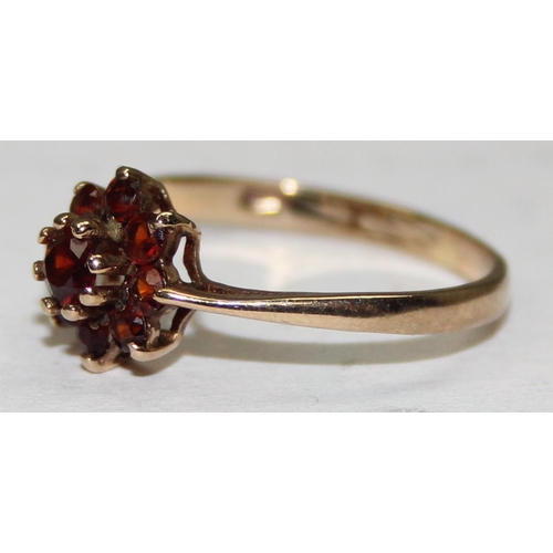 2038 - A retro 9ct gold floral set ring, possibly Garnets, London 1975, approx size L, approx 1.22g gross