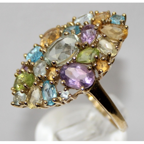 2050 - A retro style 9ct gold cocktail ring set with a large qty of a different coloured stone, full Englis... 