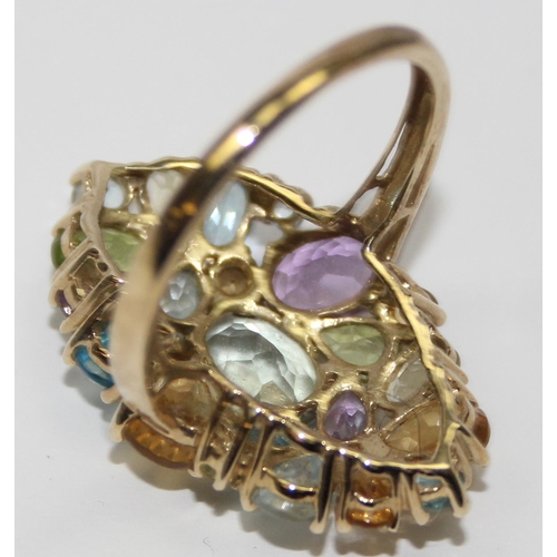 2050 - A retro style 9ct gold cocktail ring set with a large qty of a different coloured stone, full Englis... 