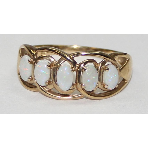 2055 - A 9ct gold ring set with a line of 5 opals, full English hallmarks, approx size T, approx 2.61g gros... 