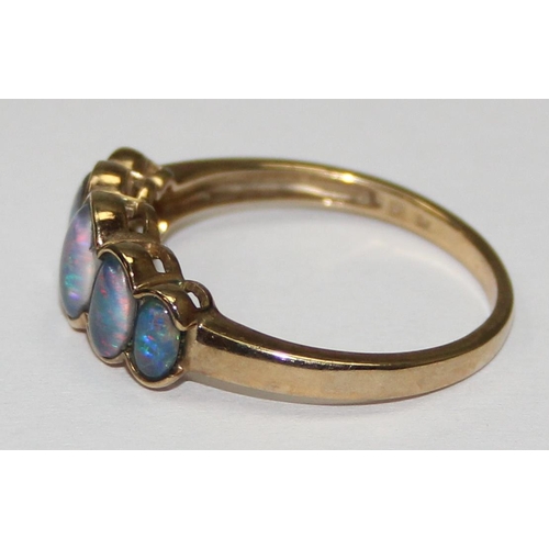 2056 - A 9ct gold ring set with a graduated line of 5 black opal type stones, possibly triplets, full Engli... 