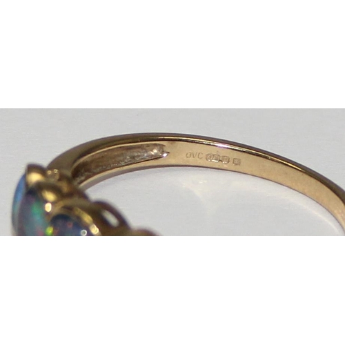 2056 - A 9ct gold ring set with a graduated line of 5 black opal type stones, possibly triplets, full Engli... 