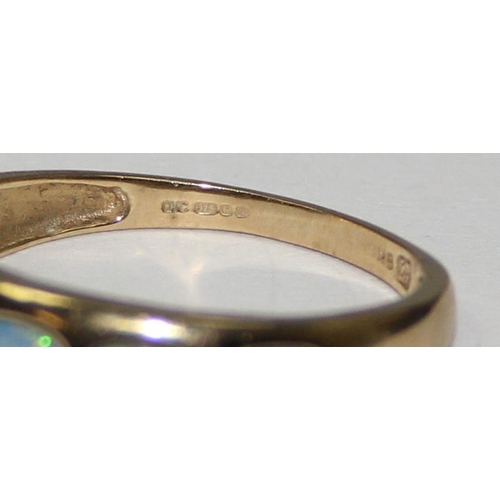 2057 - A 9ct gold ring set with a graduated line of 5 opals, full English hallmarks, approx size T, approx ... 