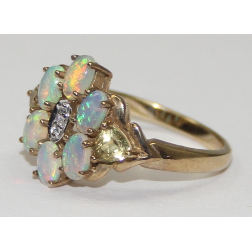 2058 - A 9ct gold opal and small diamond cluster ring set flanked by other coloured stones, full English ha... 