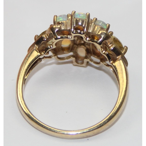 2058 - A 9ct gold opal and small diamond cluster ring set flanked by other coloured stones, full English ha... 