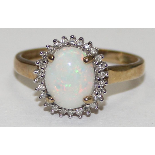 2061 - A 9ct gold oval shaped opal and small diamond ring, full English hallmarks, approx size S, approx 2.... 