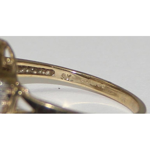 2063 - A 9ct gold oval shaped mother of pearl cabochon ring flanked by small diamonds, full English hallmar... 