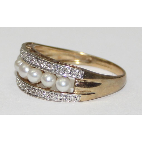 2065 - A 9ct gold seed pearl and diamond half eternity band ring, full English hallmarks, approx size T, ap... 