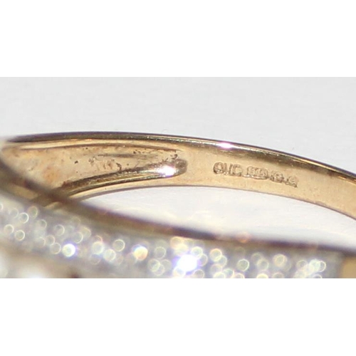 2065 - A 9ct gold seed pearl and diamond half eternity band ring, full English hallmarks, approx size T, ap... 