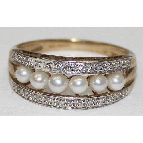 2065 - A 9ct gold seed pearl and diamond half eternity band ring, full English hallmarks, approx size T, ap... 