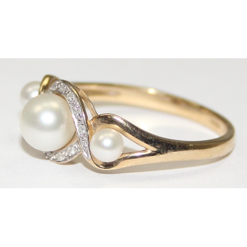 2066 - A 9ct gold trilogy pearl and small diamond ring, full English hallmarks, approx size U, approx 3.09g... 