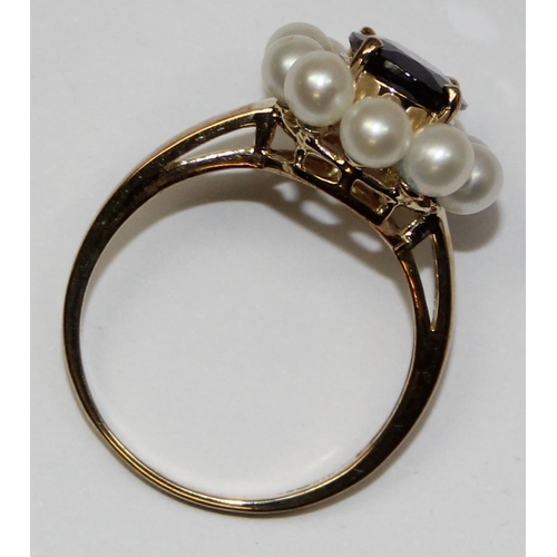 2068 - A 9ct gold floral set dress ring, a central facet cut red stone surrounded by 10 small pearls, full ... 