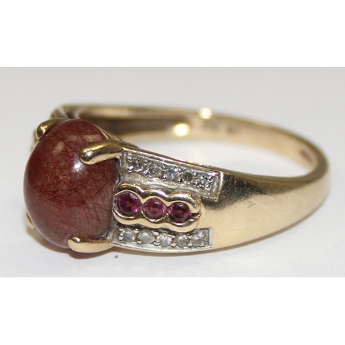 2071 - A retro style 9ct gold dress ring, an oval rutilated quartz stone flanked by small diamonds and othe... 