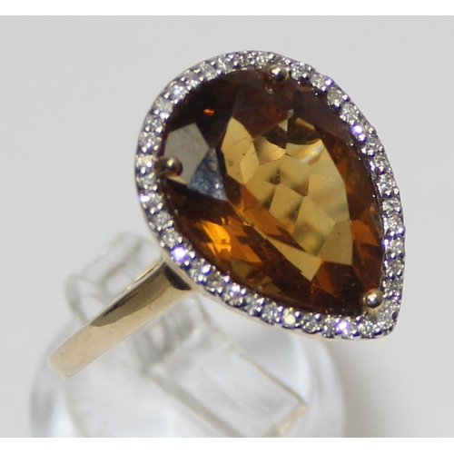 2073 - An antique style 9ct gold dress ring, a facet cut pear shaped citrine surrounded by small diamonds, ... 