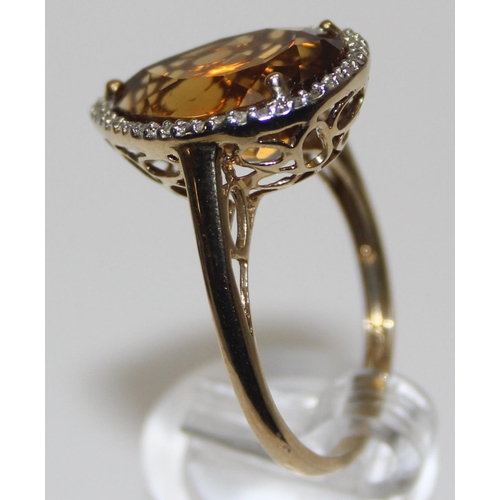 2073 - An antique style 9ct gold dress ring, a facet cut pear shaped citrine surrounded by small diamonds, ... 