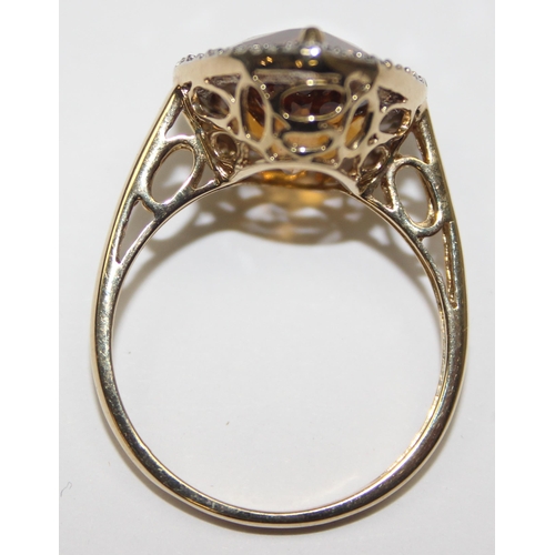 2073 - An antique style 9ct gold dress ring, a facet cut pear shaped citrine surrounded by small diamonds, ... 