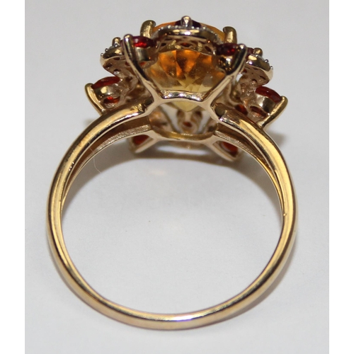 2076 - A retro style 9ct gold citrine dress ring, a large facet cut central stone surrounded by a ribbon of... 