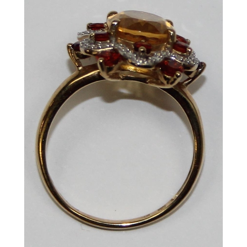 2076 - A retro style 9ct gold citrine dress ring, a large facet cut central stone surrounded by a ribbon of... 