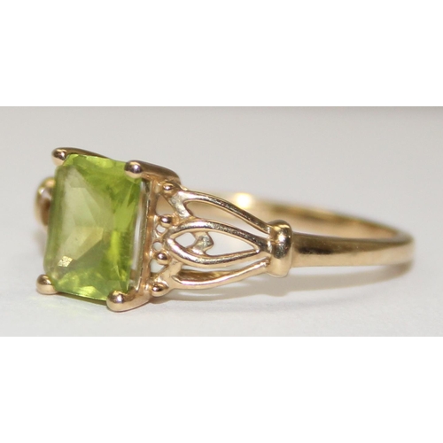 2080 - An Edwardian style 9ct gold green stone ring, likely a peridot, with decorative pierced shoulders, f... 