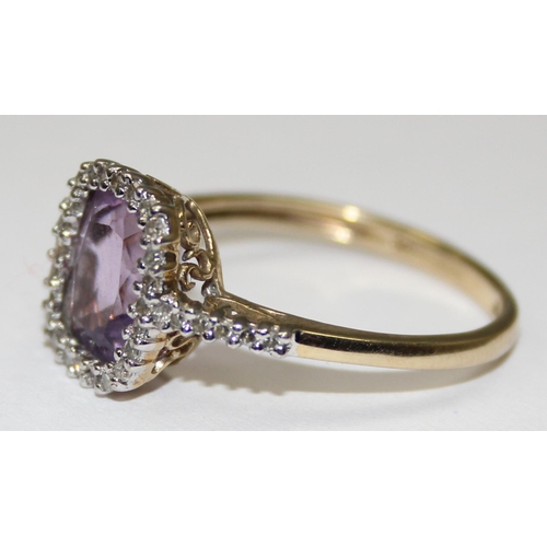 2086 - A 9ct gold antique style light purple stone cocktail ring surrounded by small diamonds, full English... 