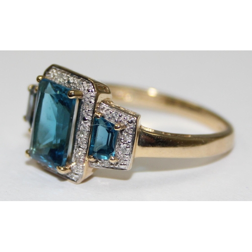 2089 - A 9ct gold Art Deco style trilogy blue stone cocktail ring surrounded by small diamonds, full Englis... 