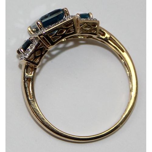 2089 - A 9ct gold Art Deco style trilogy blue stone cocktail ring surrounded by small diamonds, full Englis... 