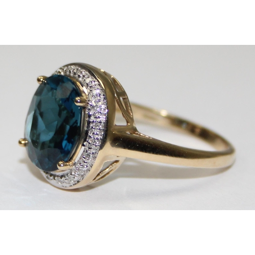 2090 - A 9ct gold antique style blue stone cocktail ring surrounded by small diamonds, full English hallmar... 