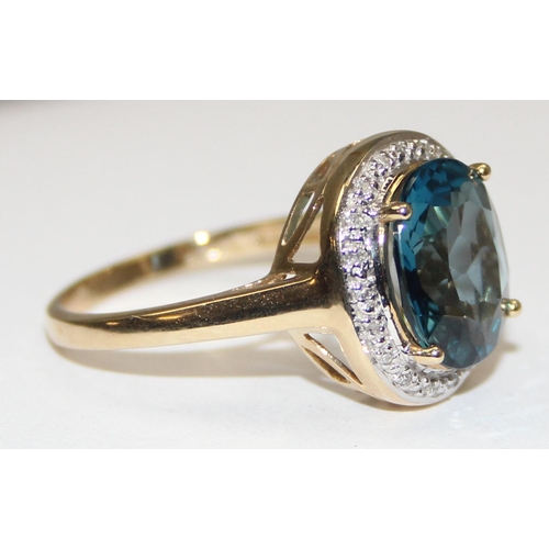 2090 - A 9ct gold antique style blue stone cocktail ring surrounded by small diamonds, full English hallmar... 