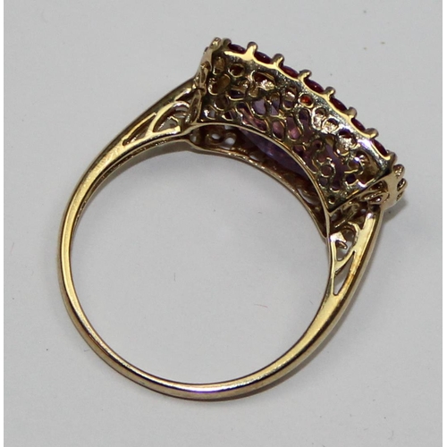 2093 - A 9ct gold Georgian style ring in decorative mounting, a large facet cut light purple stone surround... 