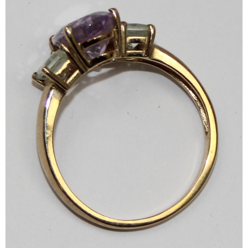 2106 - A 9ct gold trilogy ring, a light purple stone flanked by 2 white stones, full English hallmarks, app... 