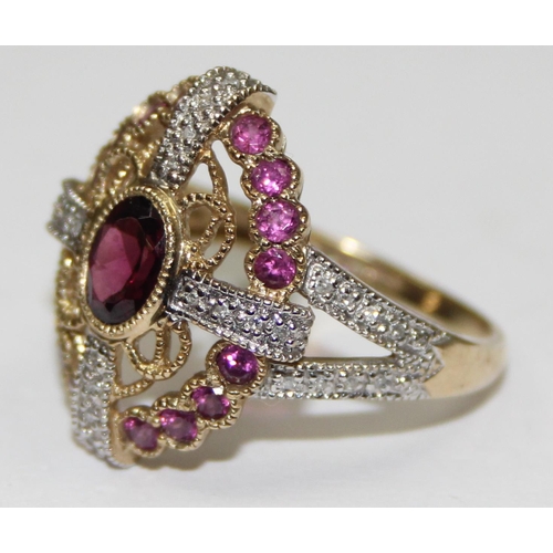 2133 - An unusual 9ct gold antique style dress ring, a large central amethyst flanked by smaller amethysts ... 