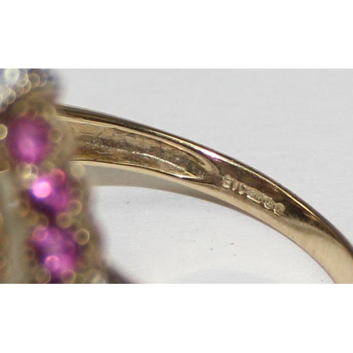 2133 - An unusual 9ct gold antique style dress ring, a large central amethyst flanked by smaller amethysts ... 