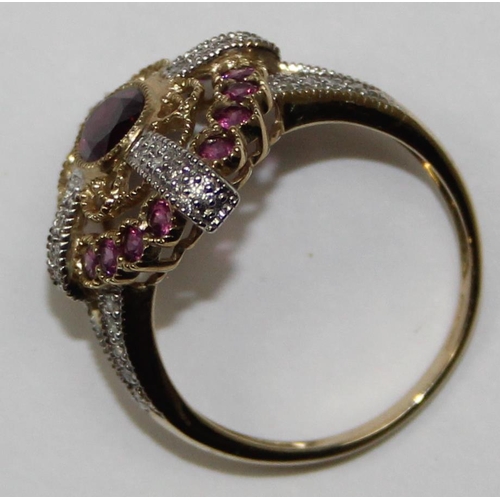 2133 - An unusual 9ct gold antique style dress ring, a large central amethyst flanked by smaller amethysts ... 