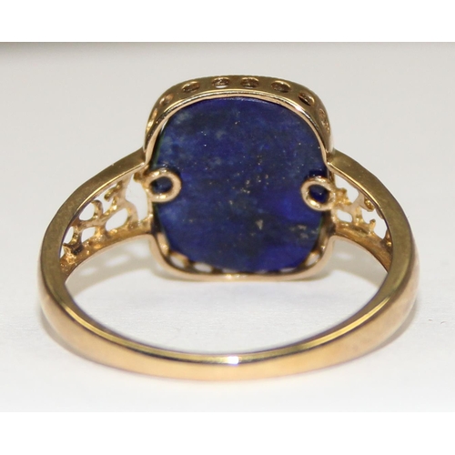 2134 - An unusual 9ct gold antique style dress ring, a large central cabochon of Lapis overlaid with small ... 