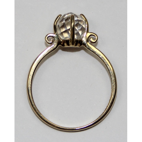 2140 - An unusual 9ct gold ring with a facet cut white crystal orb in claw setting, full English hallmarks,... 