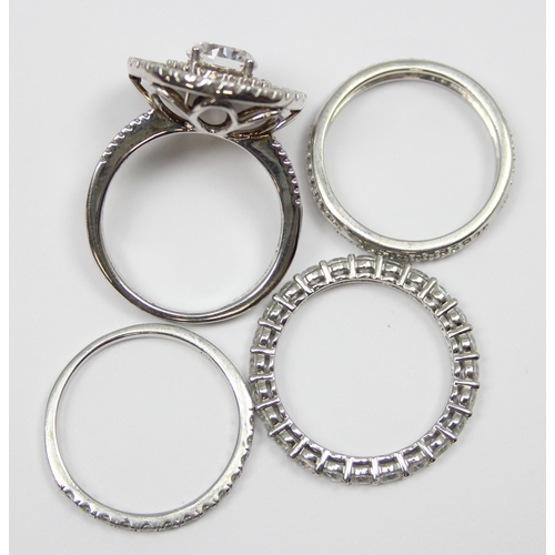 2184 - 4 assorted 925 silver dress rings, mainly white stones in various designs, all approx size T