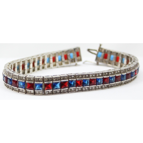 2273 - An Art Deco style 925 silver tennis bracelet, an alternating row of red and blue stones flanked on e... 