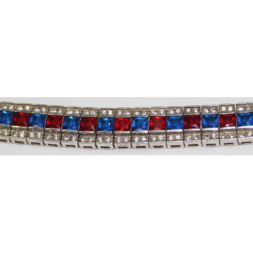 2273 - An Art Deco style 925 silver tennis bracelet, an alternating row of red and blue stones flanked on e... 